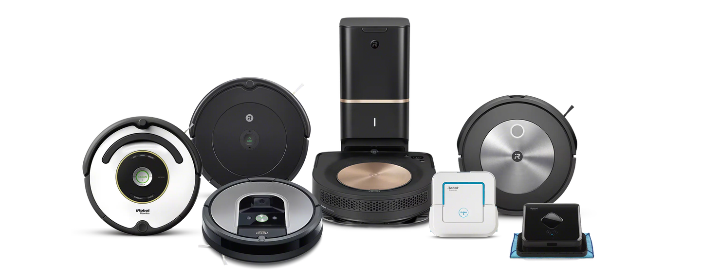 A family plays in the kitchen behind images of iRobot&rsquo;s collection of robot vacuums and mops.